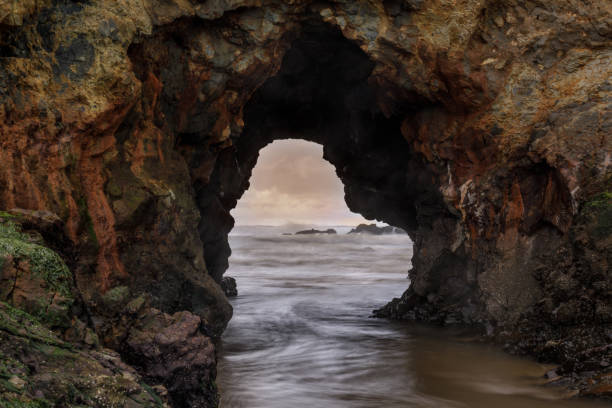 istock Pescadero Arch Rock closeup during winter sunset 1195613950