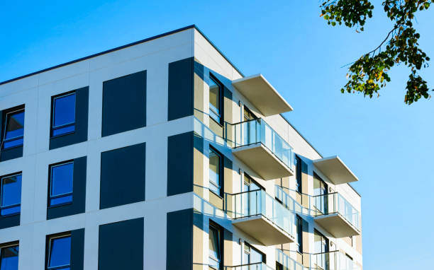 istock Facade modern apartment house copy space green tree reflex 1195615099