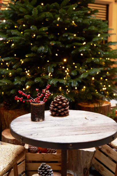 istock Christmas tree with festive table with mandarins, oranges and pine tree cone 1195615206