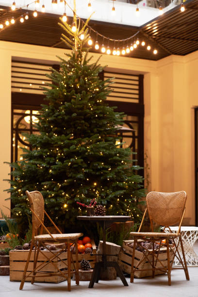 istock Christmas tree with festive table with mandarins, oranges and pine tree cone 1195615312