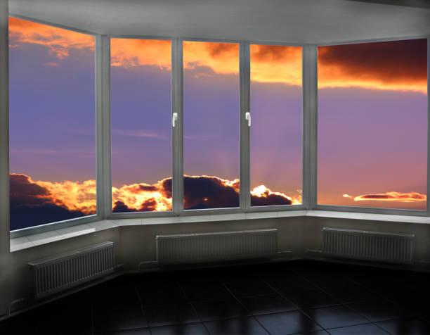 istock Plastic windows overlooking beautiful crimson sunset. View from home window 1195616460
