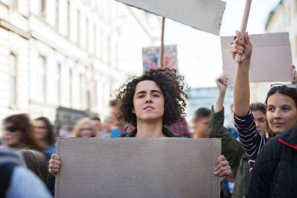 istock People with placards and posters on global strike for climate change. 1195621769