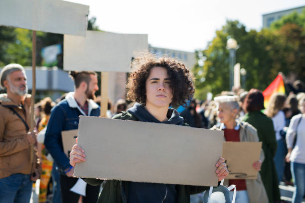 istock People with placards and posters on global strike for climate change. 1195621789