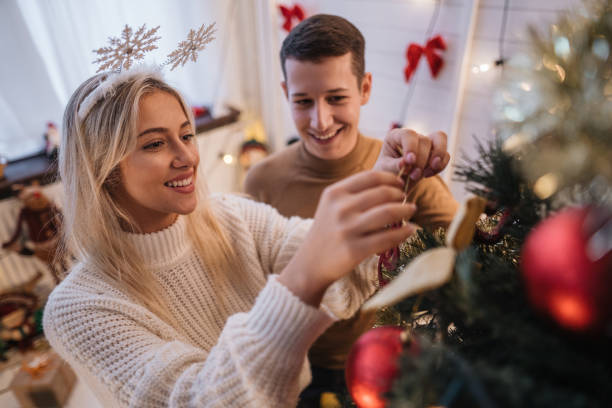 istock Beautiful couple decorating a Christmas tree 1195621837