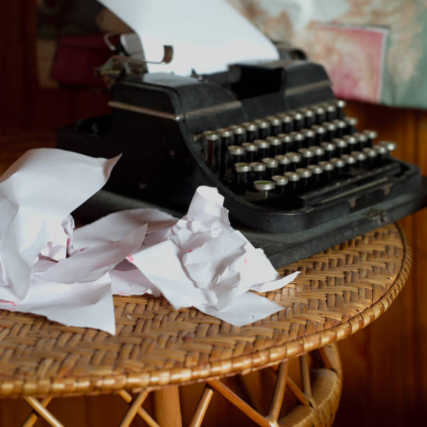 istock Old typewriter and heap of paper 1195622760