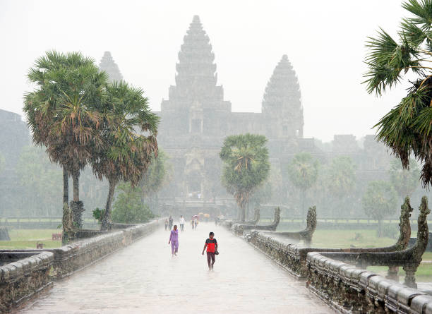 dilúvio tropical, complexo do templo de angkor wat, siem reap, camboja. - flood people asia cambodia - fotografias e filmes do acervo