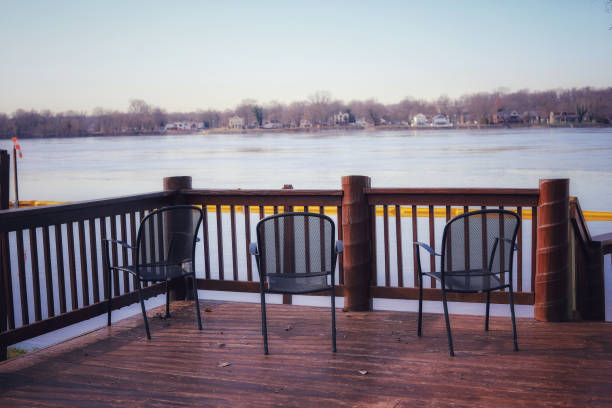 istock A  set of black chairs on a deck facing the river 1195627153
