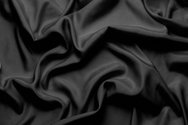 istock Black silk with beautiful waves. Can be used as a background or wallpaper 1195628012