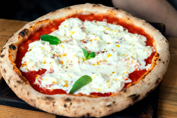 istock Freshly baked pizza on a wooden table 1195628852