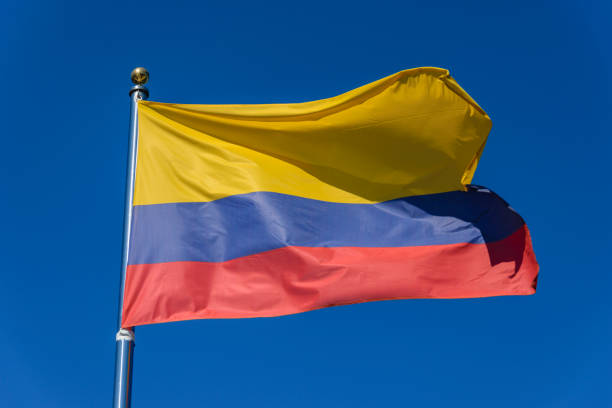 istock Flag of Colombia on a blue background 1195629094