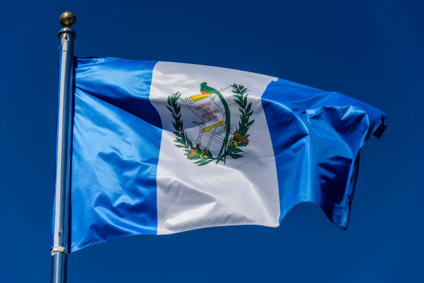 istock Flag of Guatemala on a blue background 1195629197