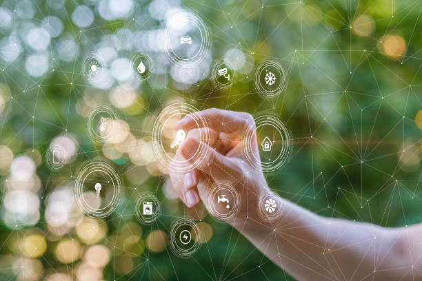 istock The hand clicks on the key structure of the smart home. 1195630147