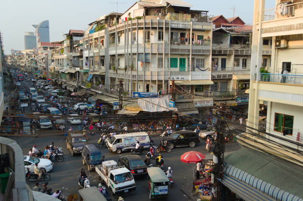 Phnom Penh, Cambodia - March, 2015: Traffic jam on a road intersection. Stuck in a traffic with crowd of motorbikes and car on the crossroad. People driving with no rules on the street.