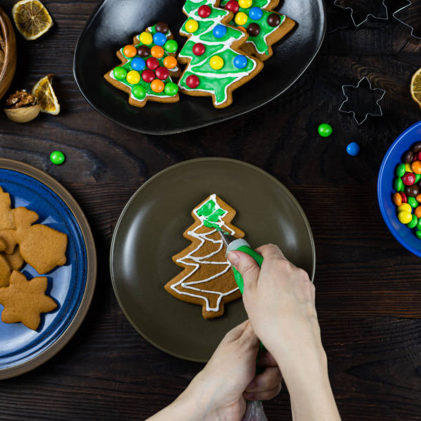istock A famales hands decorates cookies with icing 1195633673