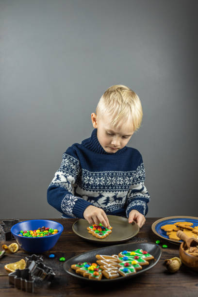 istock A child decorates cookies with icing 1195633746
