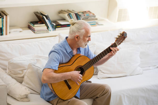istock Senior man playing acoustic guitar. 1195633841