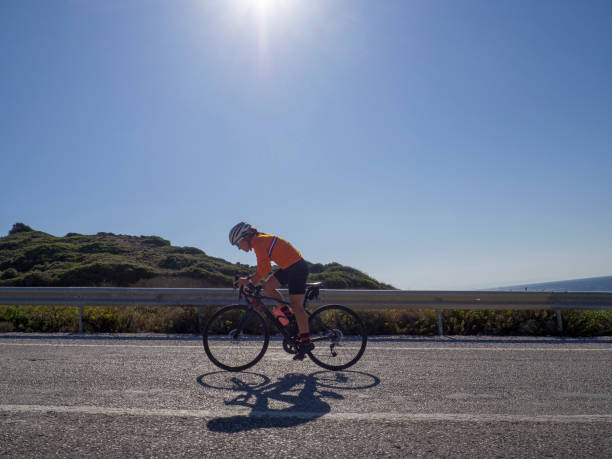 istock woman cycling road bicycle 1195635251