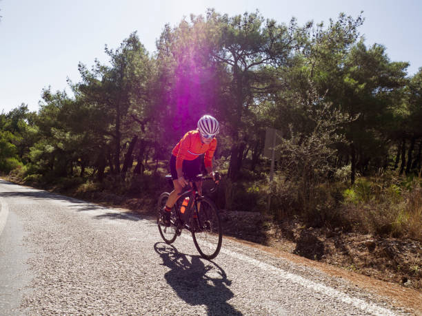 istock woman cycling road bicycle 1195635313