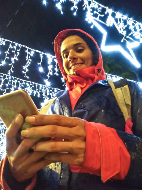 istock The Girl Using Her Phone Under Rain 1195637596