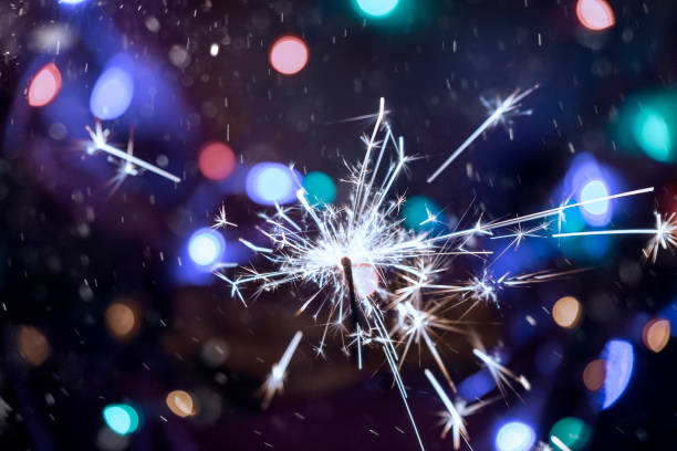 istock Burning sparkler in hands close-up 1195638940