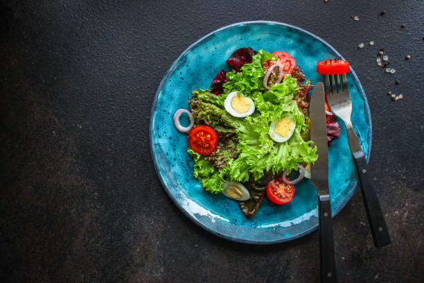 istock healthy salad quail eggs (vegetables, tomato, lettuce and other ingredients) menu concept. food background. top view. copy space 1195639030