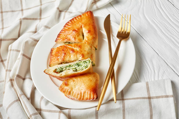 istock Calzone, closed pizza with Spinach and Cheese filling 1195639127