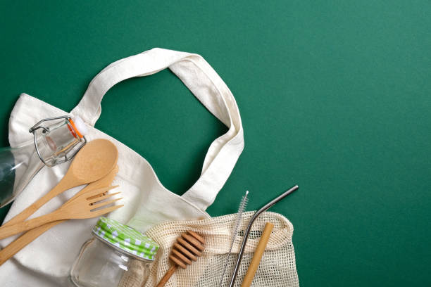istock Eco friendly bamboo kitchenware and reusable shopper bag on green background. Zero waste, plastic free concept. Sustainable lifestyle. Flat lay, top view. 1195643952