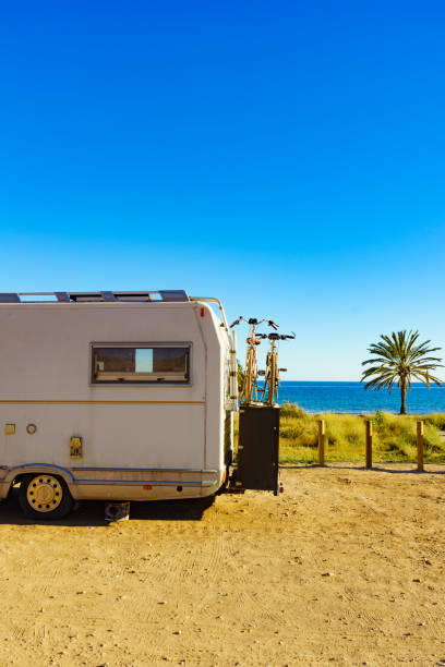 istock Camper with bicycles on beach, camping on sea 1195647148