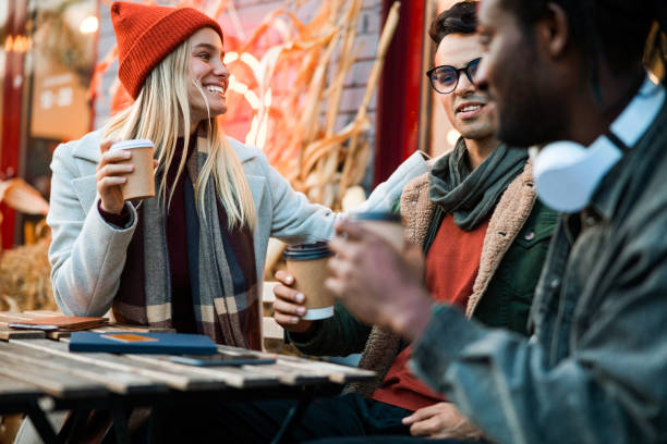 istock Pretty smiling lady talking with her friends in cafe 1195647218