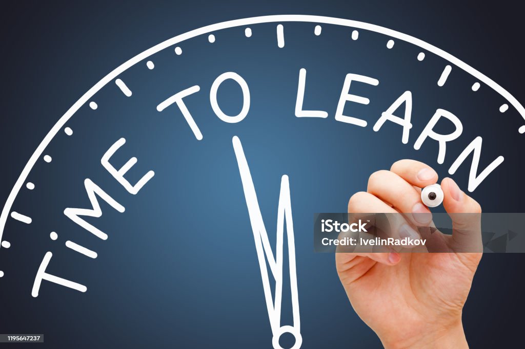Time To Learn Educational Clock Concept Hand writing Time to Learn on a clock with white marker on transparent wipe board on dark blue background. Concept about the importance of lifelong learning. Learning Stock Photo