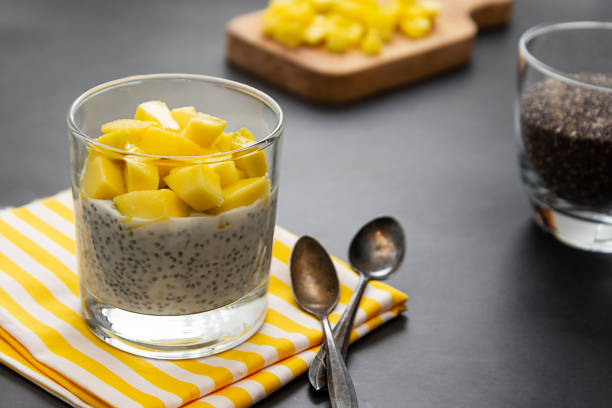 Coconut Chia seed pudding with pineapple, dark background copy space. Healthy food concept.