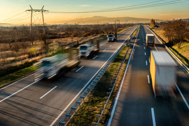 istock Delivery lorry trucks passing each other on a highway 1195649393