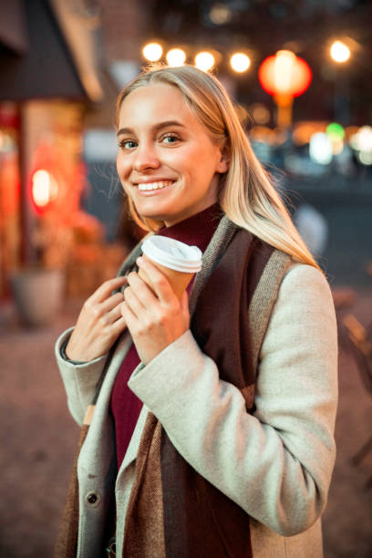 istock Smiling young lady looking at camera in the city 1195650200