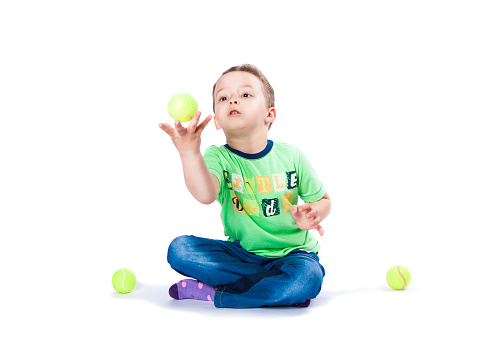 boy catches the ball on a white background