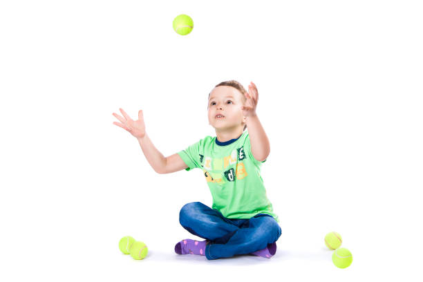 boy catches the ball on a white background