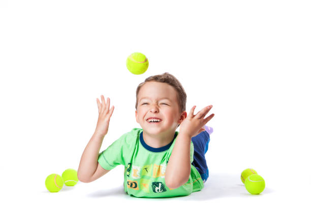 istock boy catches the ball on a white background 1195650388