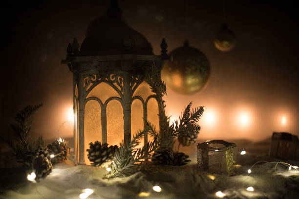 istock Creative artwork decoration. Christmas decoration with burning candles on a dark background. Christmas ornaments over dark golden background with lights. 1195651401