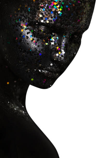 istock creative female portrait. face in black paint with large sequins 1195652295