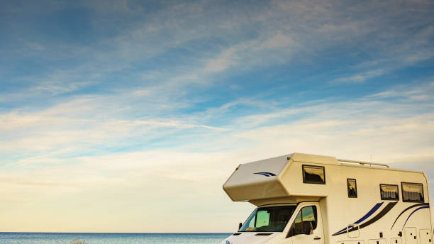 istock Camper car on beach, camping on nature 1195652387