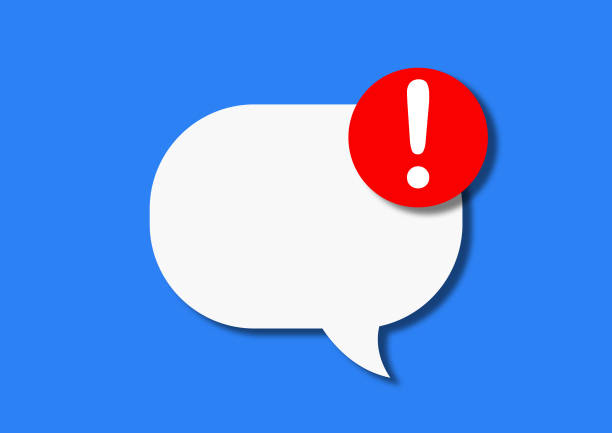 White speech bubble of paper cardboard with a red circle with a look on a blue background. Concept of notification of a new message on the phone or social networks. Flat lay, top view.