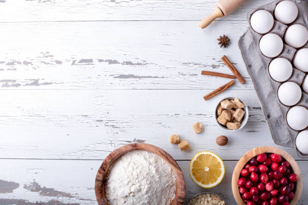 istock Baking and cooking ingredients on white wooden background 1195653563