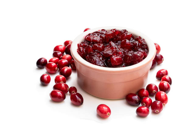 istock Fresh cranberries in ceramic pot isolated on white 1195655161