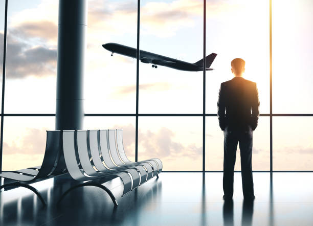istock Businessman standing in airport 1195656907