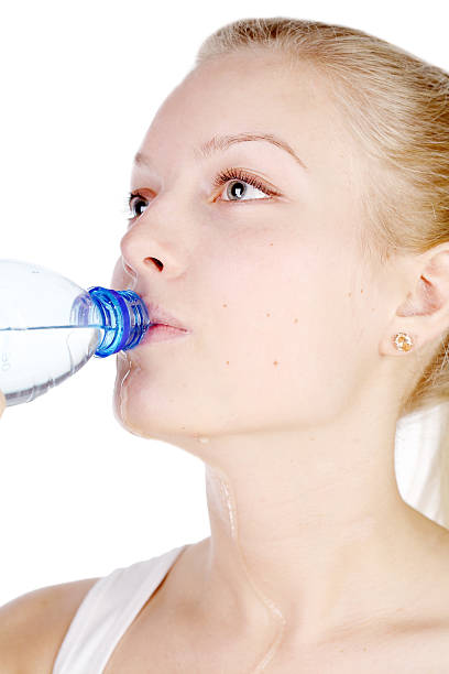 istock beautiful girl drinks mineral water from plastic bottle 119565780