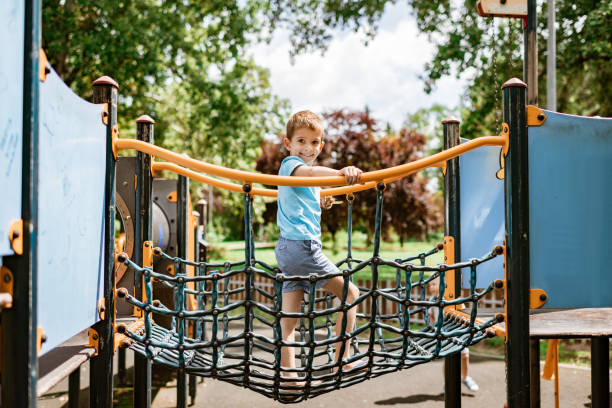 istock Boy is having fun on an outdoor playground 1195658516