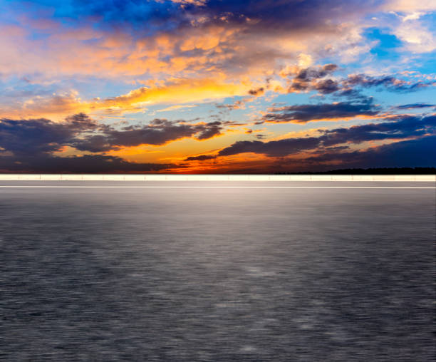 istock Car-free asphalt pavement with sunset sky. 1195661508