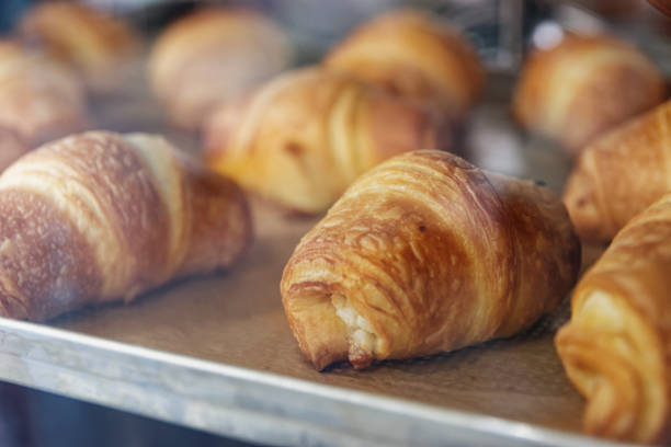 istock Baking croissants on metal sheet in oven 1195663300