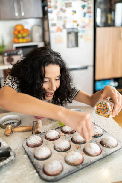 Woman decorating muffins