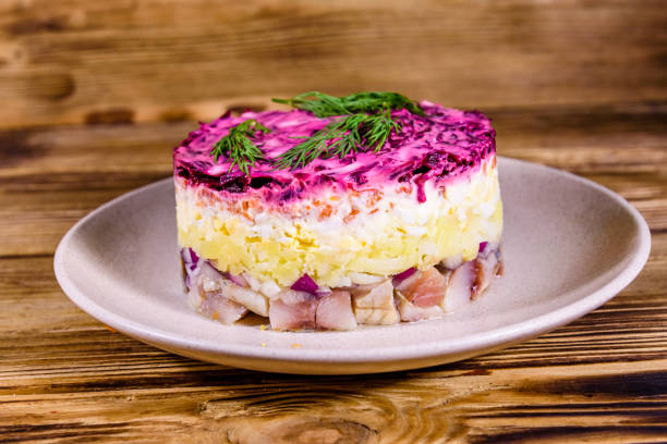 istock Ceramic plate with russian traditional new year salad herring under fur coat (shuba) and on rustic wooden table 1195664213