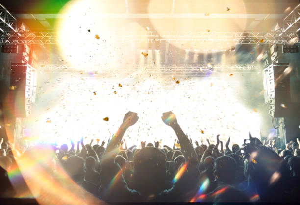 istock Concert stage, people are visible waving and clapping, silhouettes are visible 1195669474